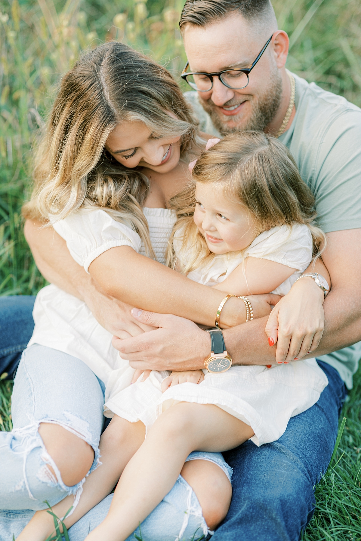 Rebecca Shivers Photography, Family of three hugging in the grass at Lancaster County Park