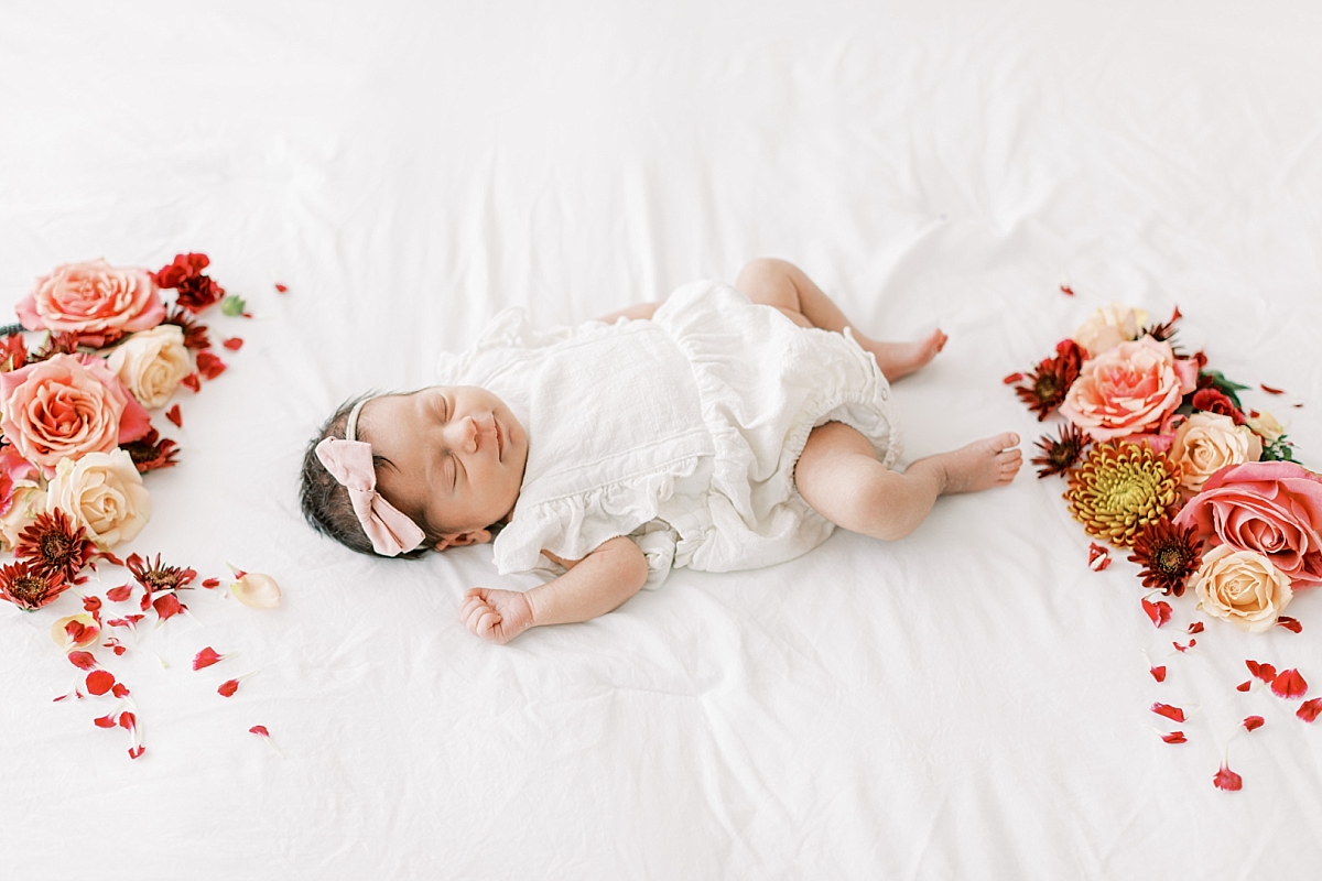 Lancaster, PA newborn photography session in studio with flowers and baby smiling