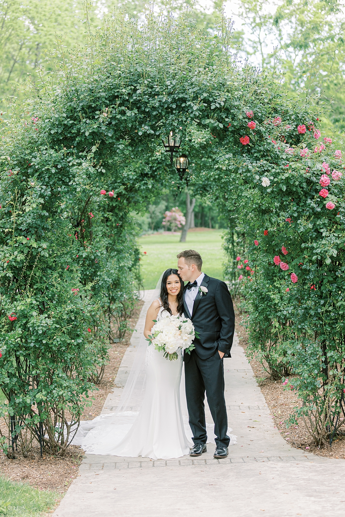 Moonstone Manor rose arch for a bride and groom