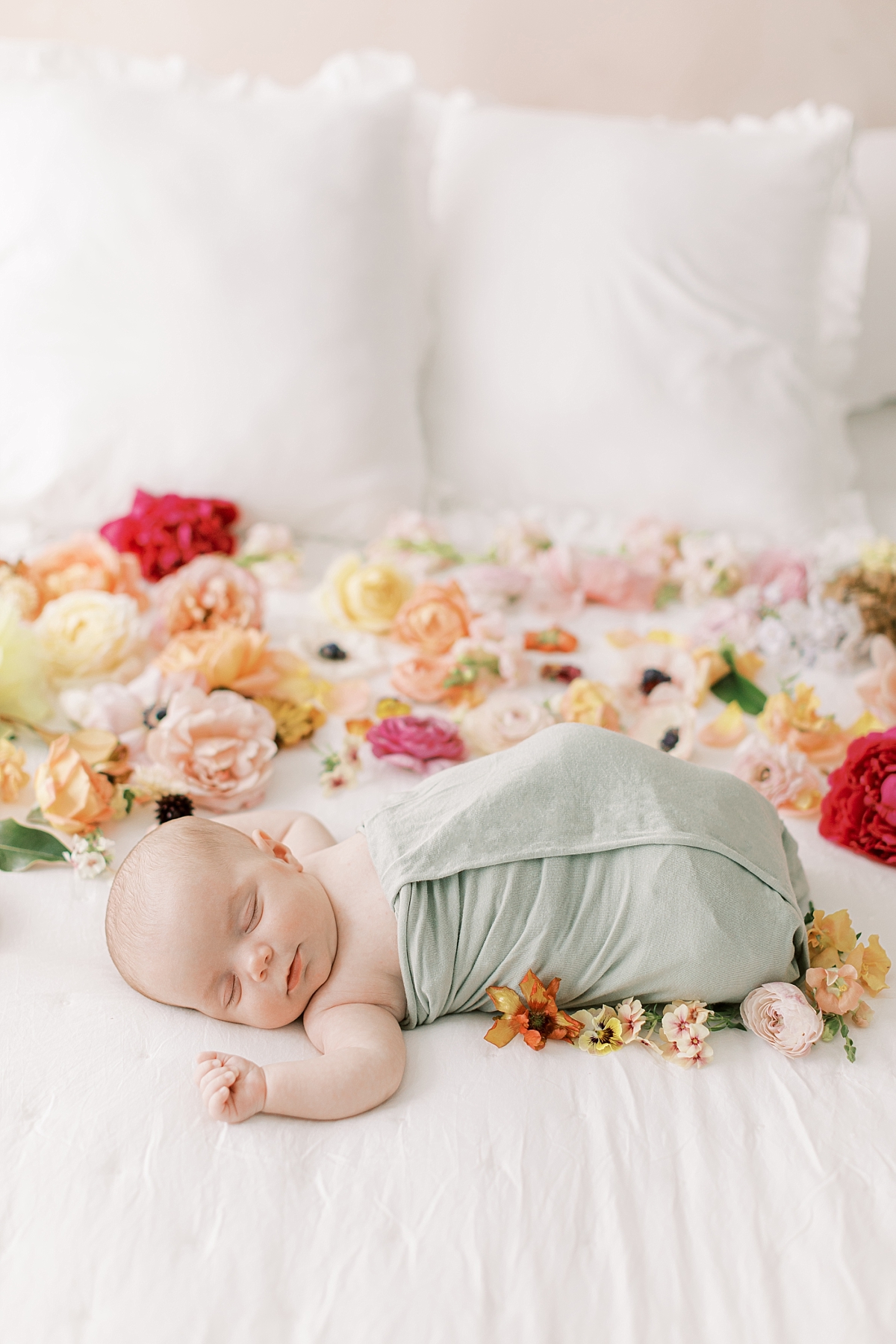 newborn laying with florals during photography session