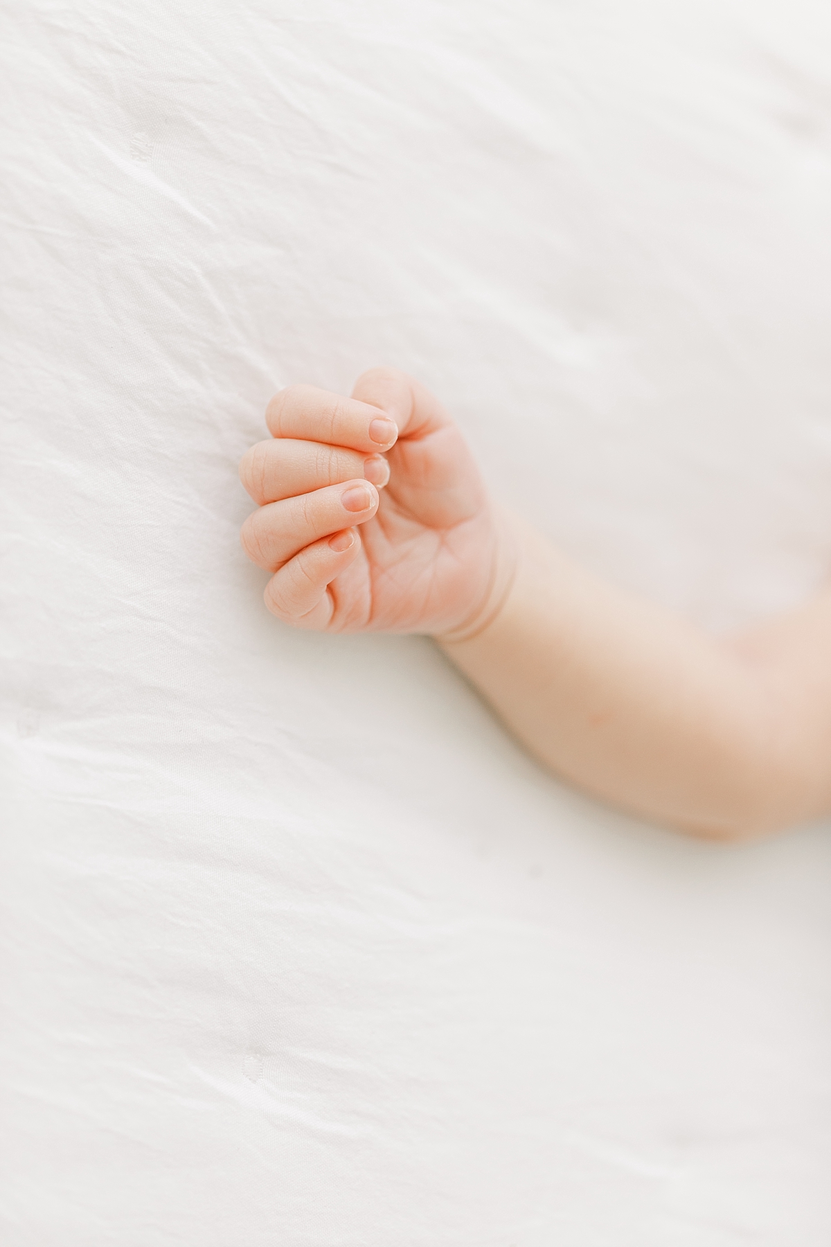 lifestyle newborn session with baby's hand