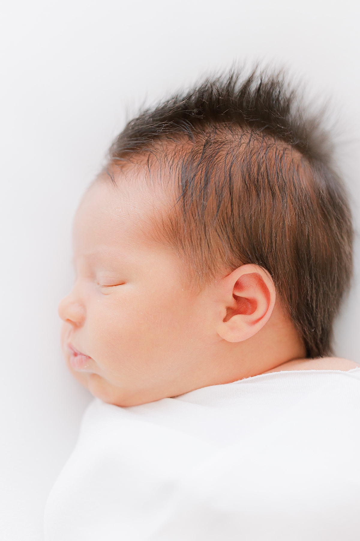 newborn photography near you of baby with lots of fuzzy hair