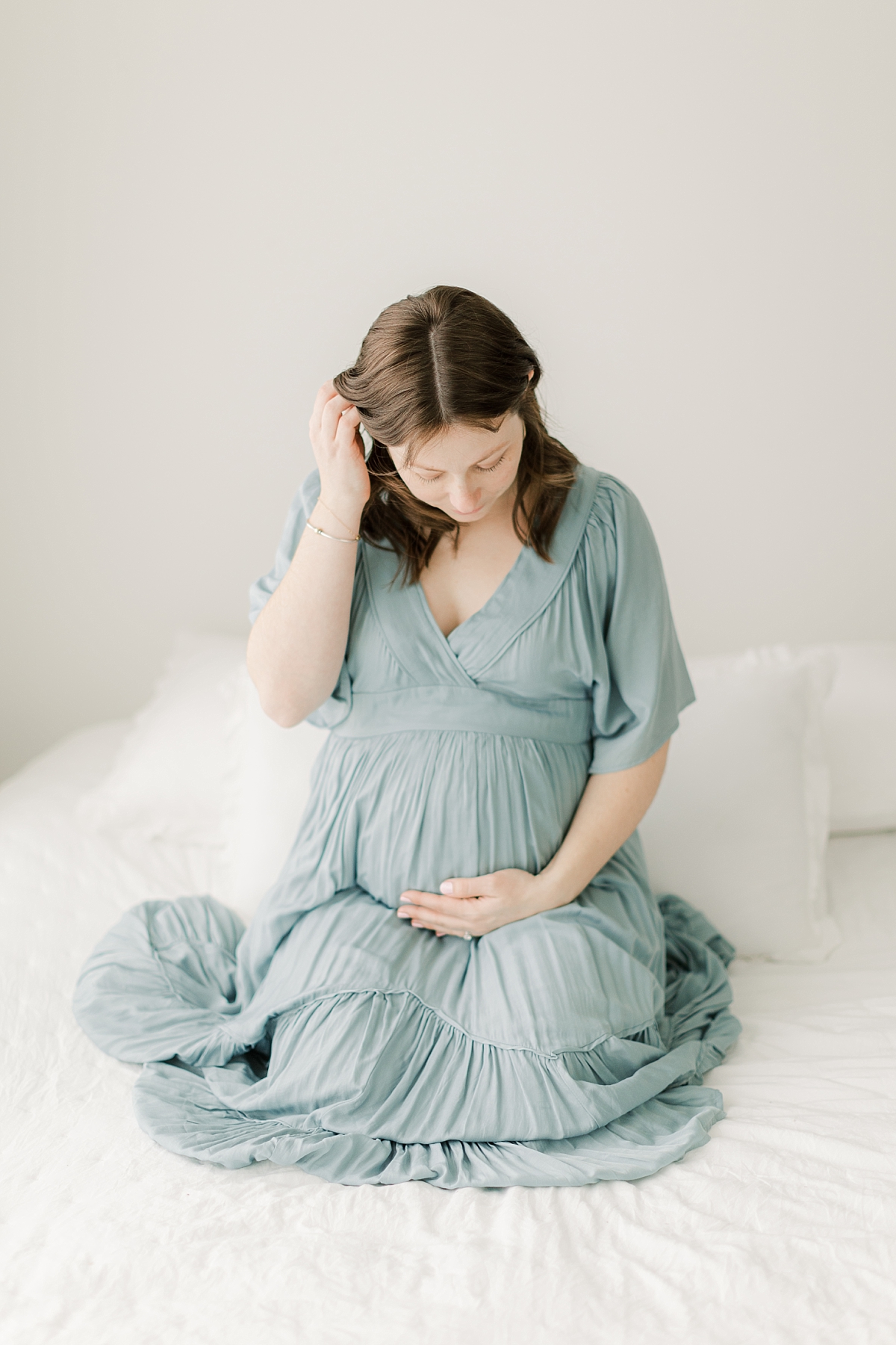 studio maternity session with mom wearing dress from client closet