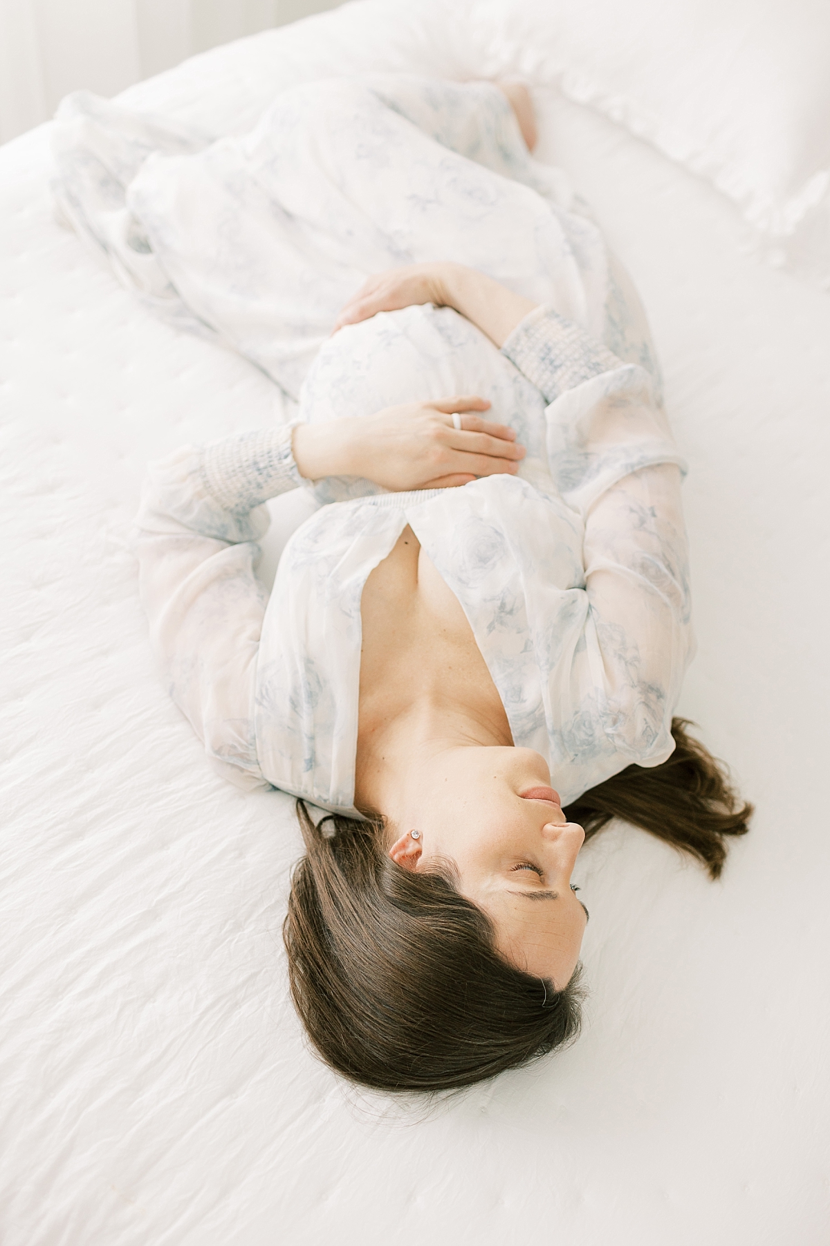 lancaster maternity session in blue laying on bed