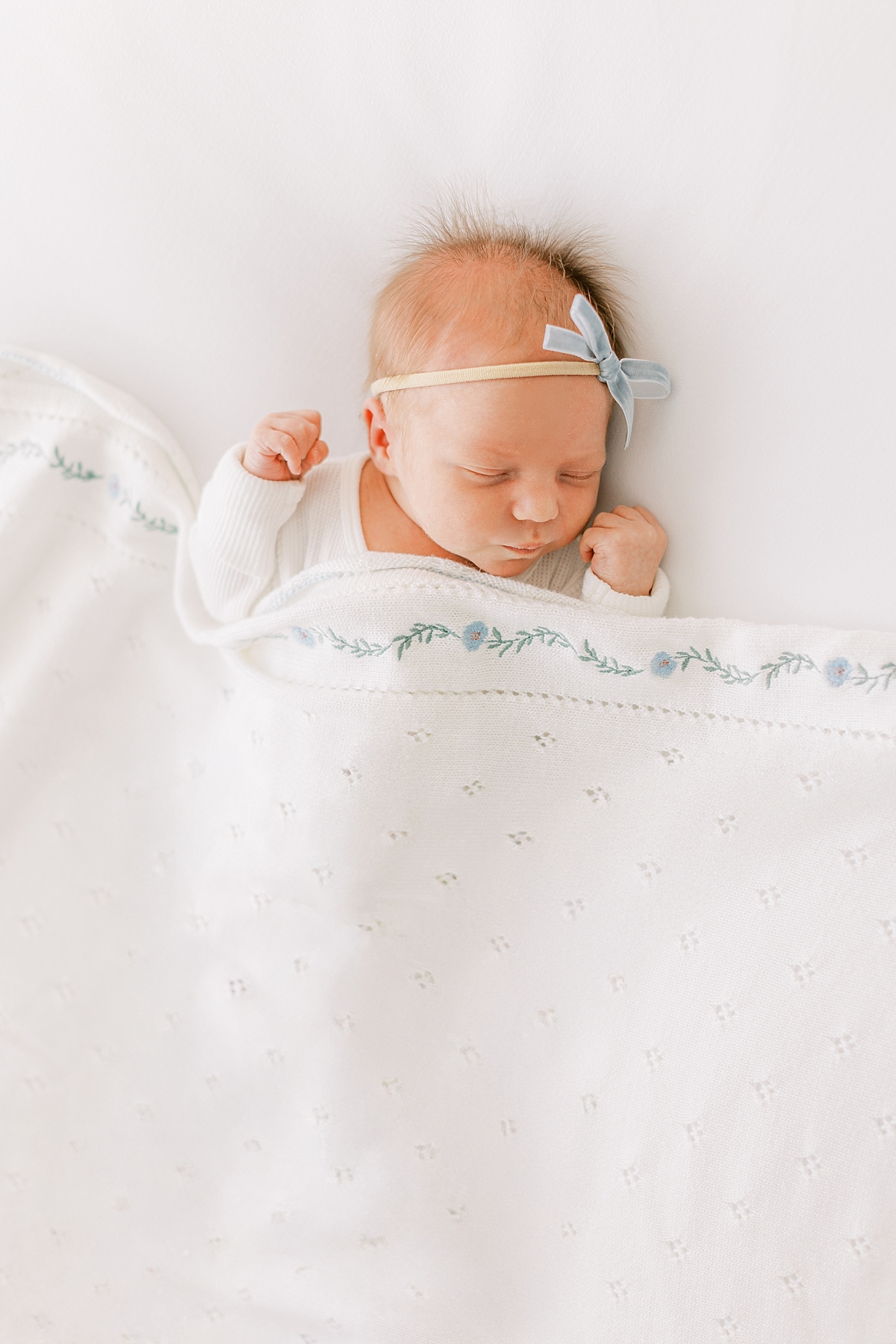 newborn girl with blue blanket

