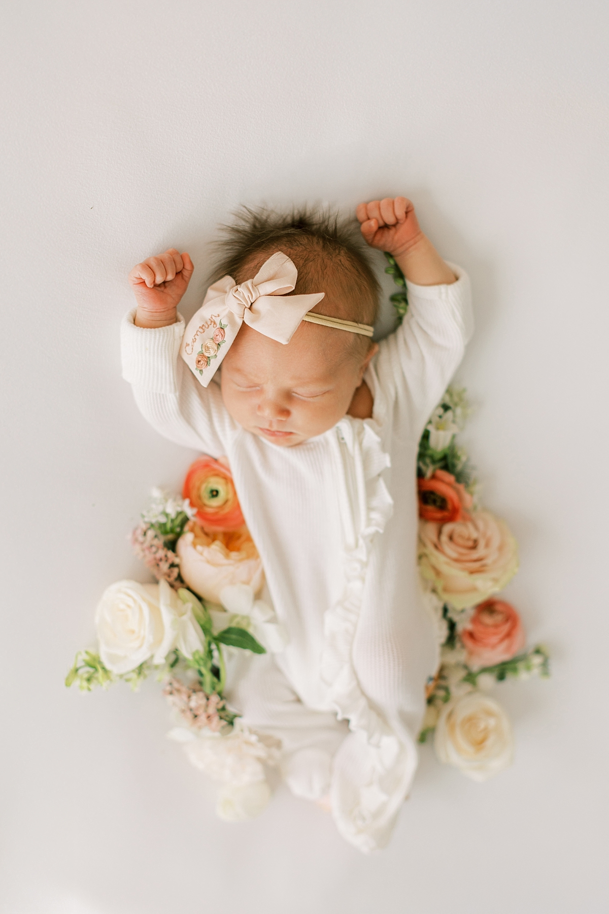 newborn baby girl with flowers
