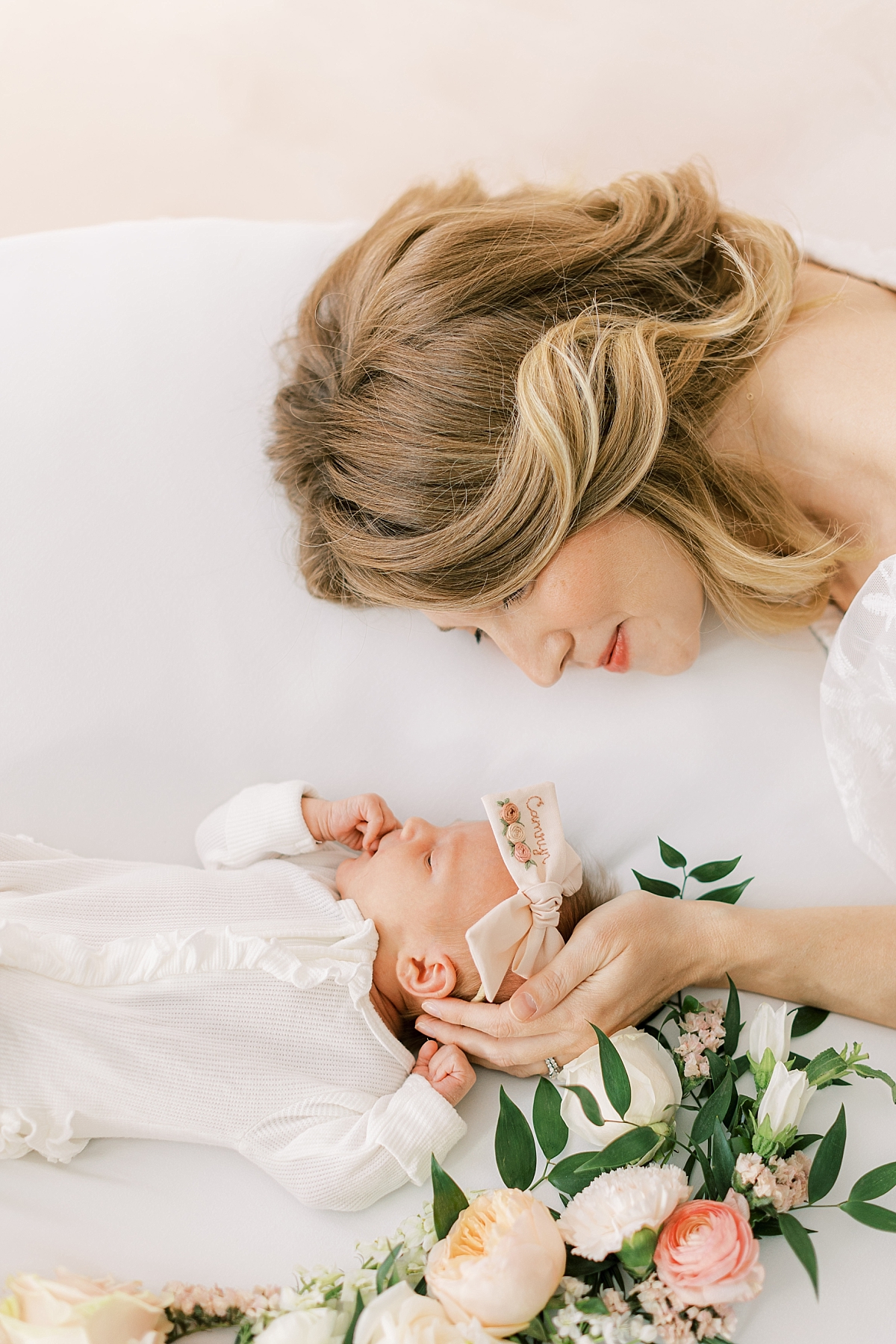 newborn baby girl with florals and mom