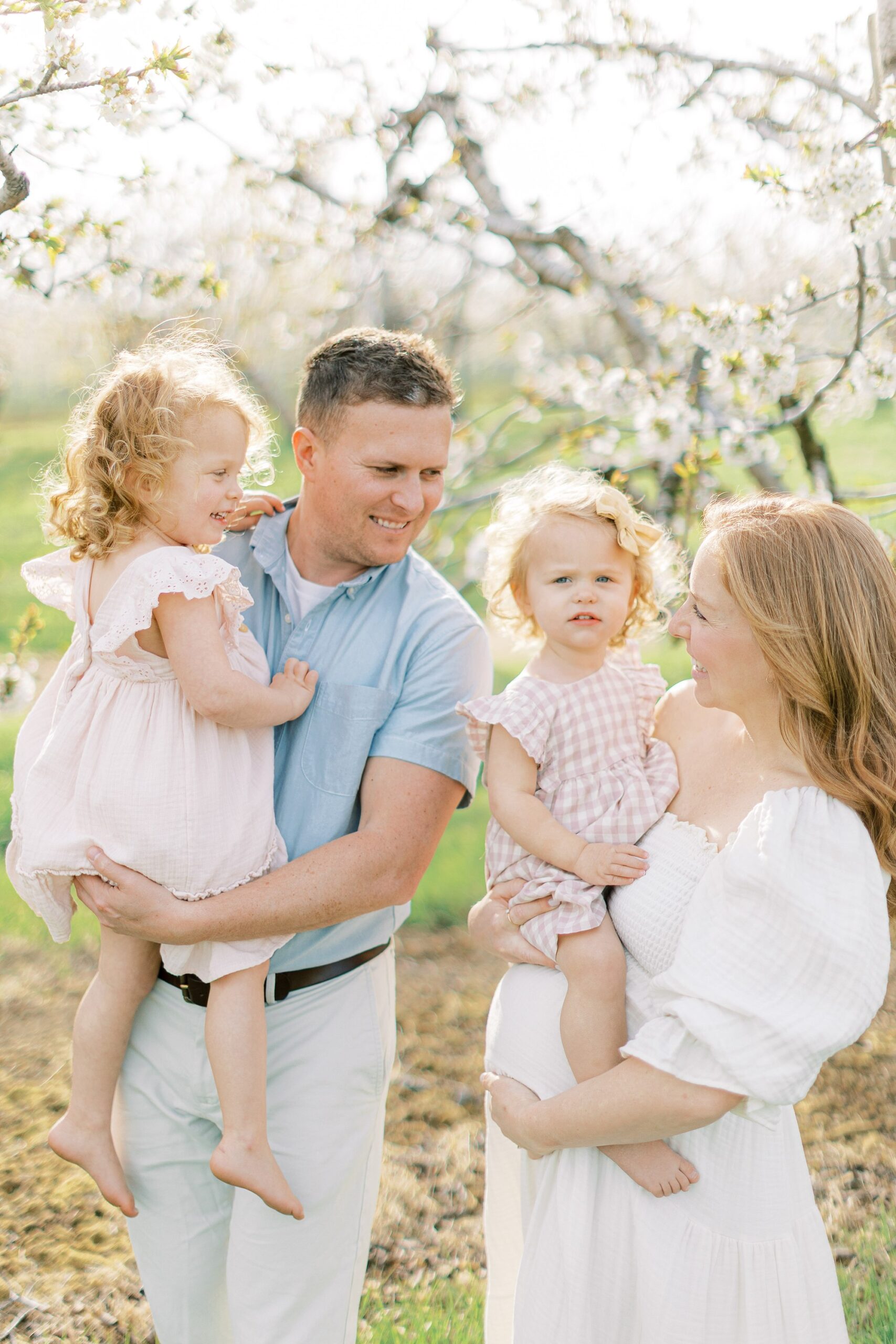 maternity session in an orchard in Lancaster county parents holding children