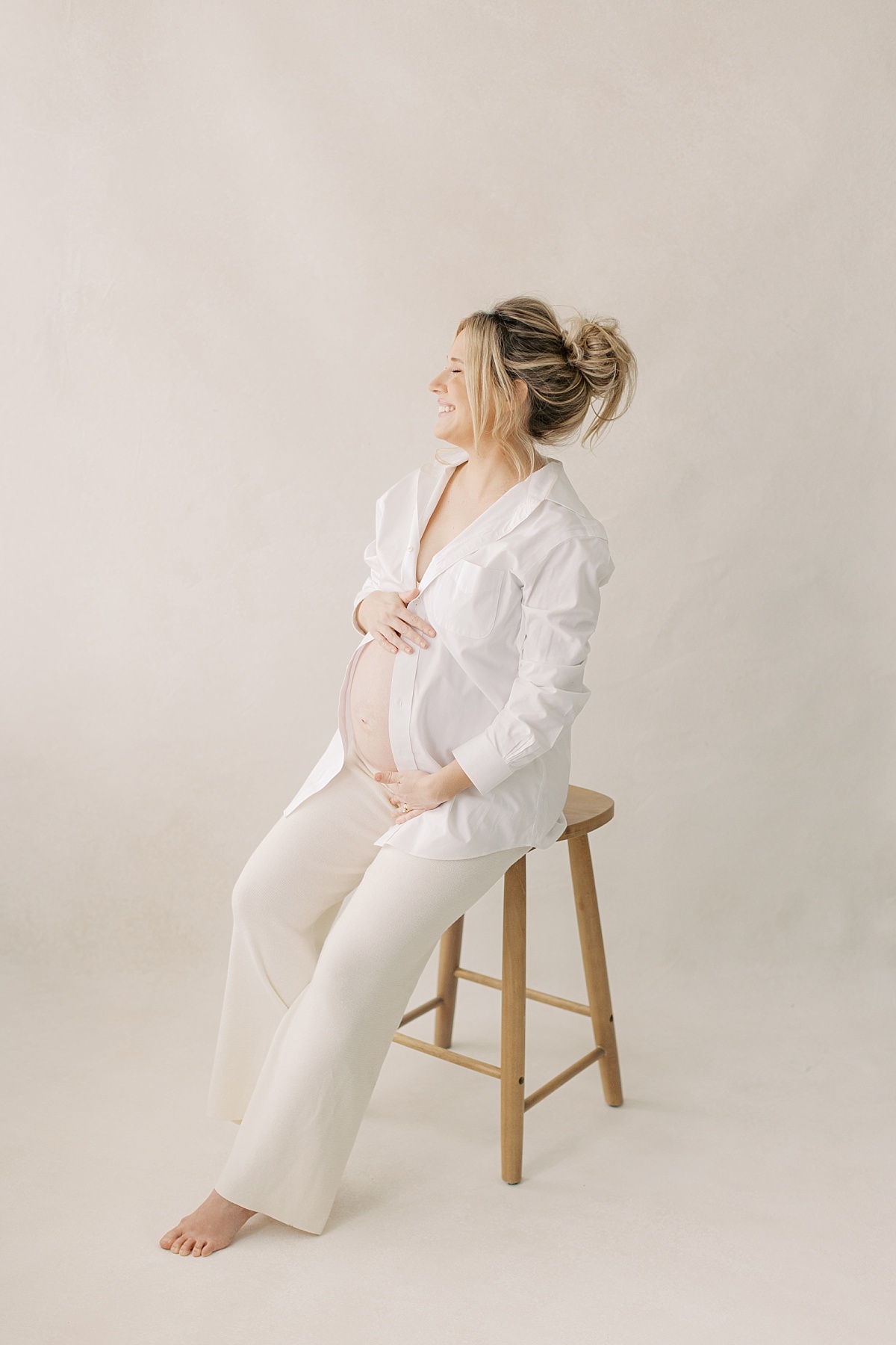 lancaster pa maternity session in winter, long with white button down shirt sitting on stool